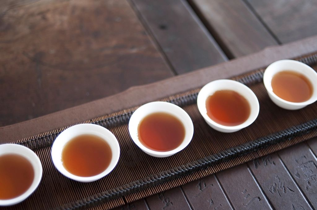 Pot of Chinese tea with small cups on a table