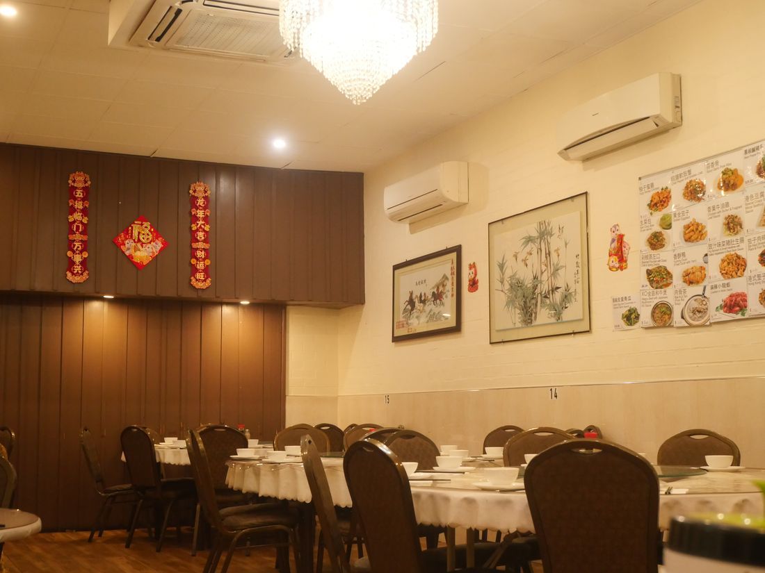 Dining hall at Fu Moon Lau with round tables and red lanterns