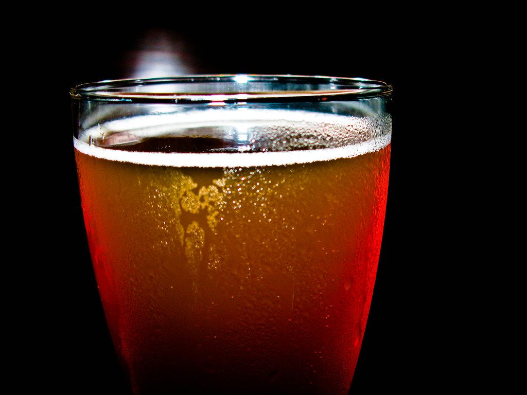 Glass of cold Japanese draft beer with foam head