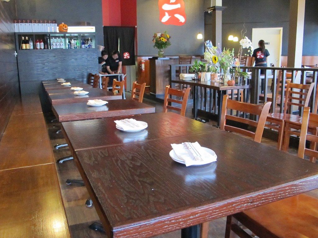 Dim wooden dining room of Akari izakaya lit by paper lanterns